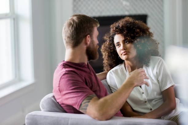 A couple talking together on a couch